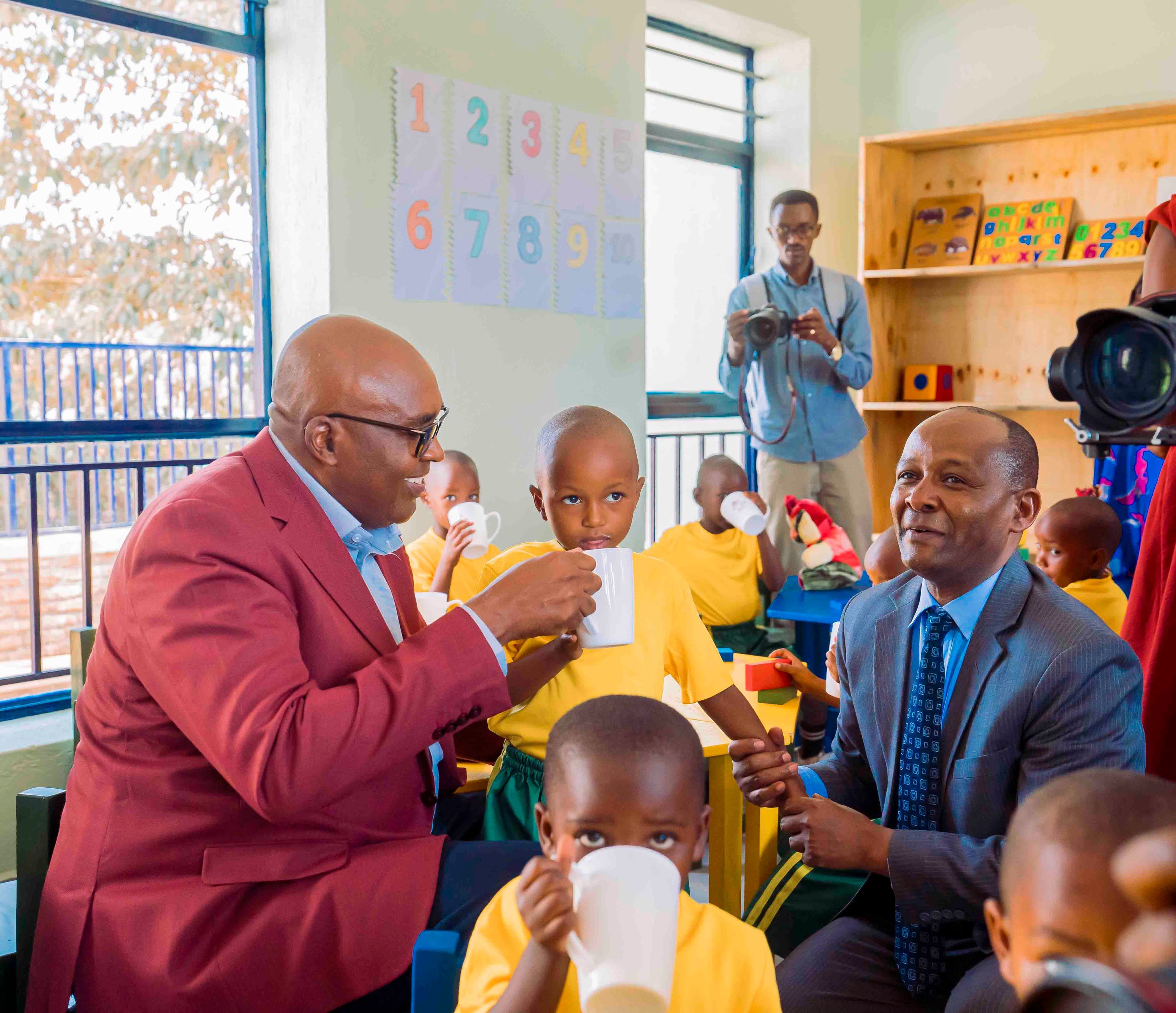 Prof. Simon Gicharu, Founder and Chairman of Mount Kigali University, and the Vice-Chancellor, Dr. Martin Kimemia share a moment with children at the Kinyinya ECD&F Centre, serving milk as part of MKU’s commitment to supporting the children’s nutrition and wellbeing.