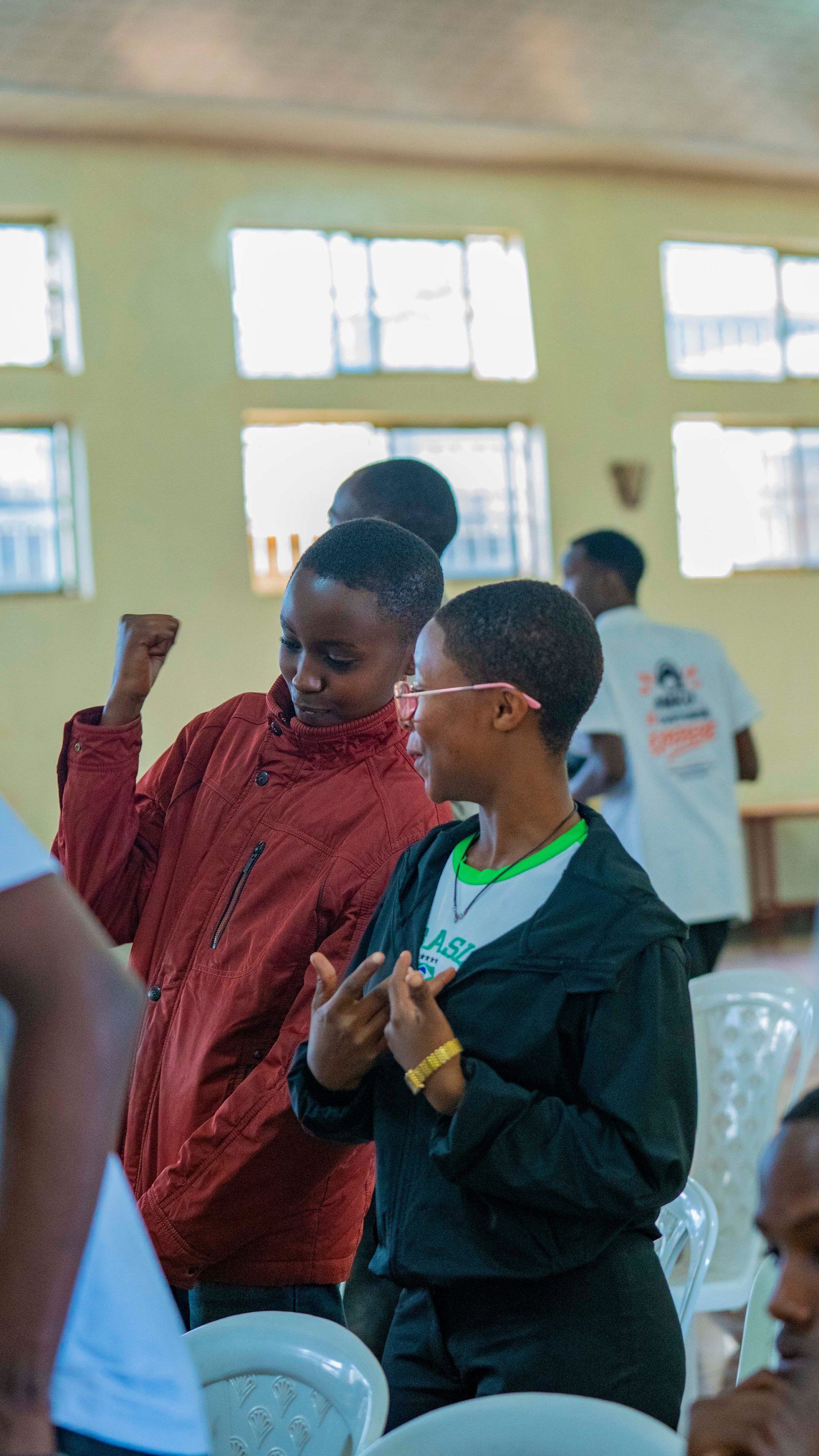 High school students enjoy a lively moment during the Rise and Speak Rwanda mentorship session, dancing and having fun together while building confidence, strengthening social connections, and expressing themselves freely.