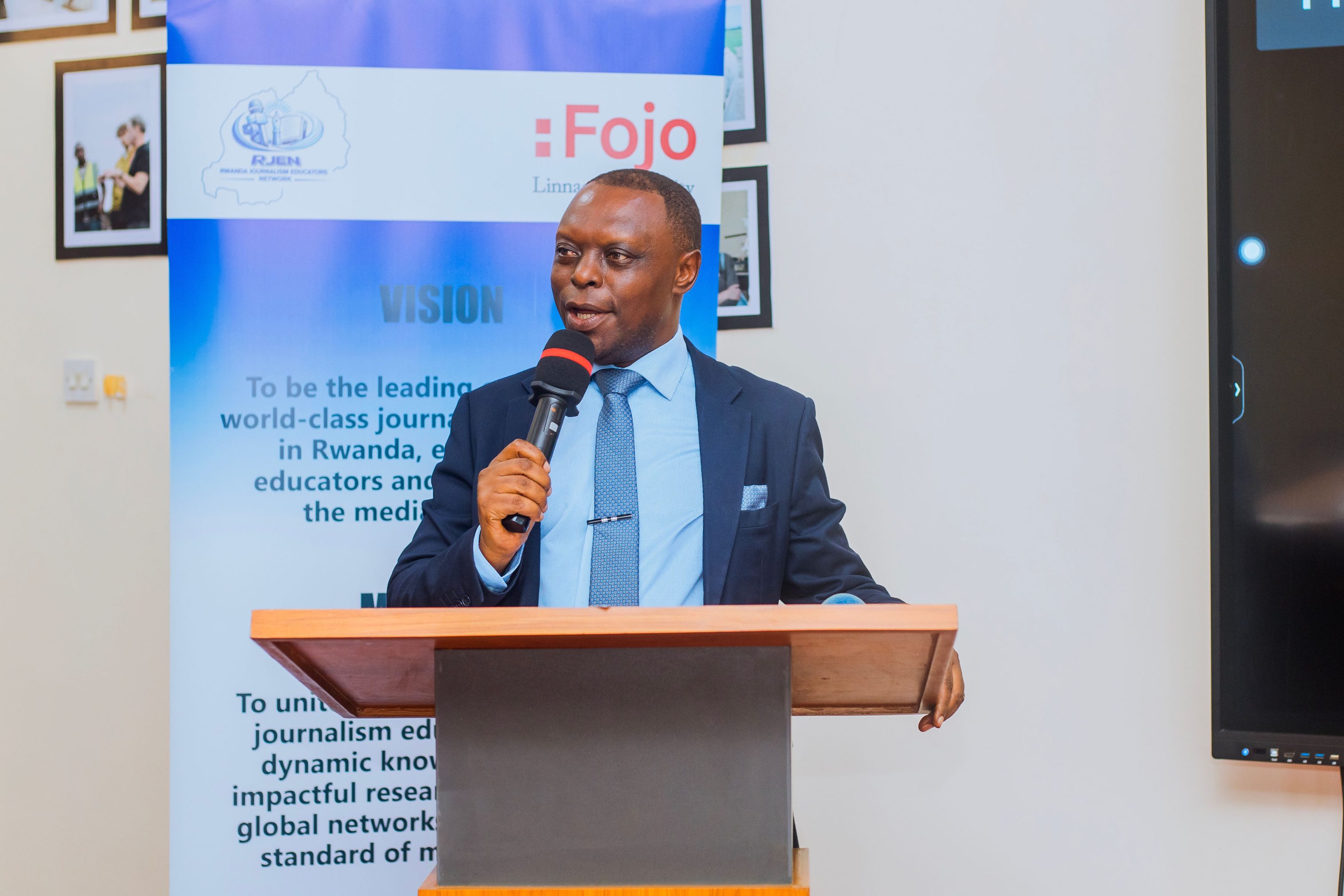 A speaker addresses participants during the meeting, contributing to discussions on press accreditation, freedom of expression, and the need for stronger collaboration among journalism educators and media stakeholders.